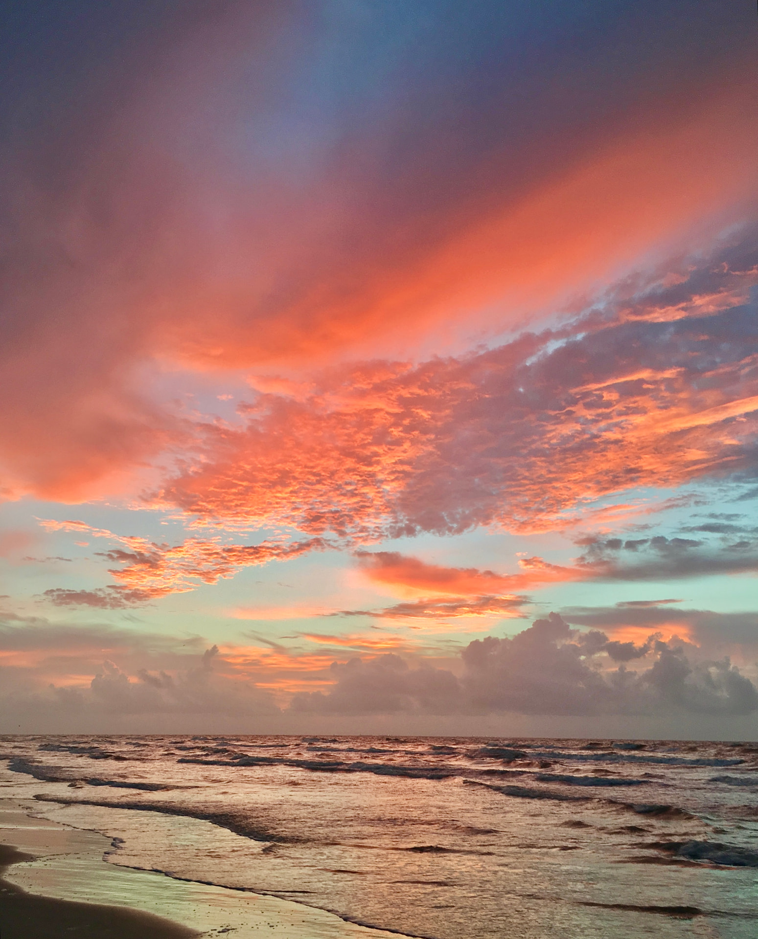 Coral Clouds Over the Gulf
